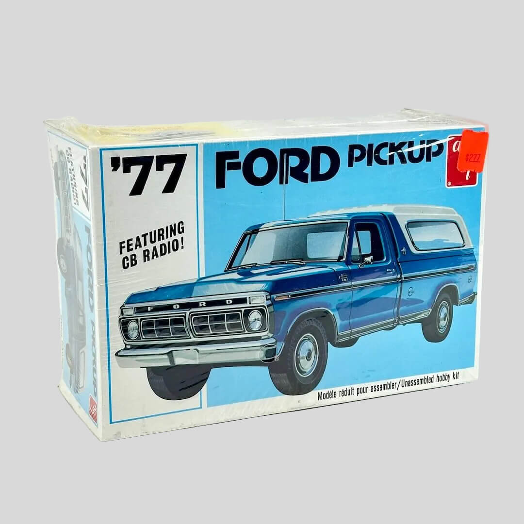 Model kit for '77 Ford Pickup still in plastic wrap against white background. 