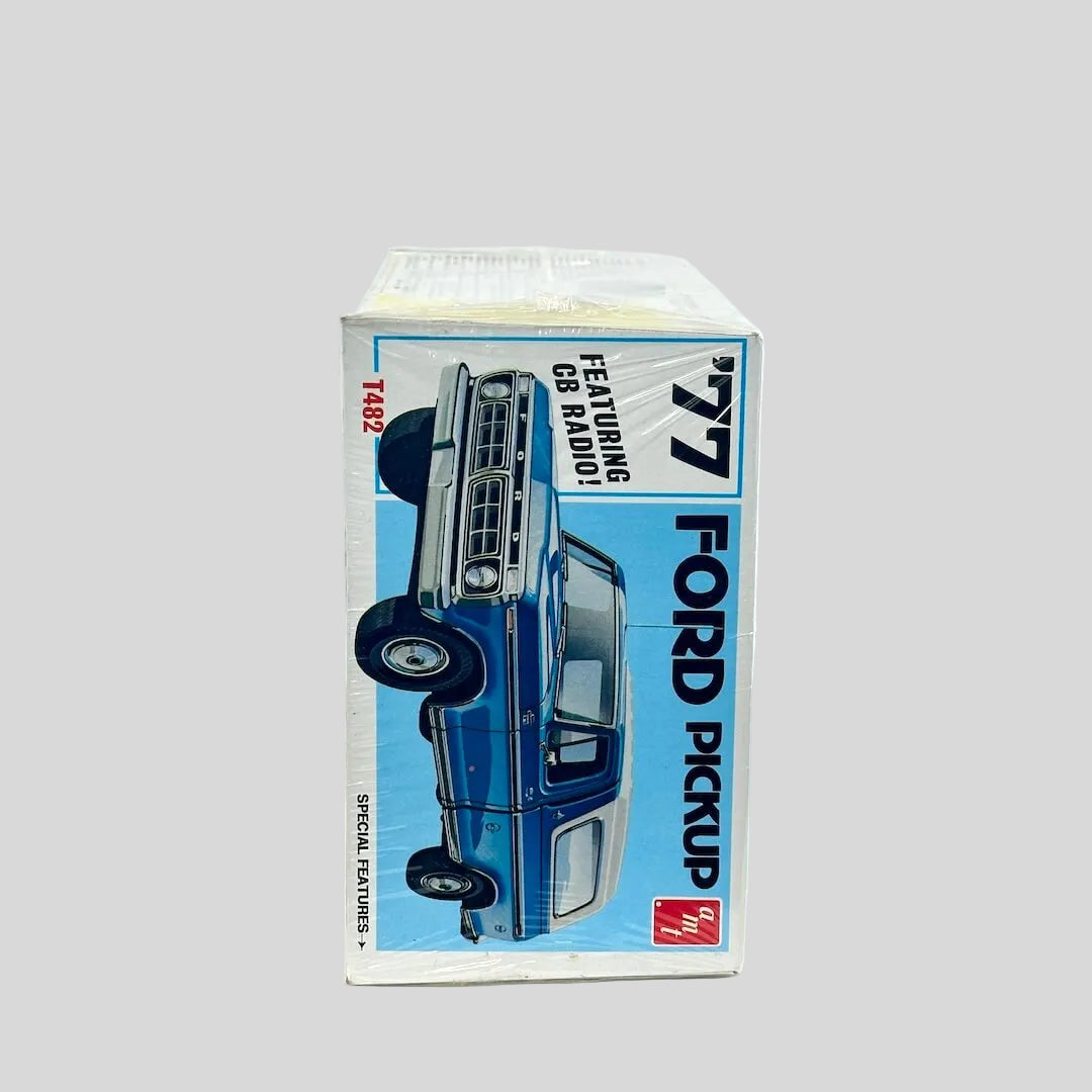 Model kit for '77 Ford Pickup still in plastic wrap against white background. 