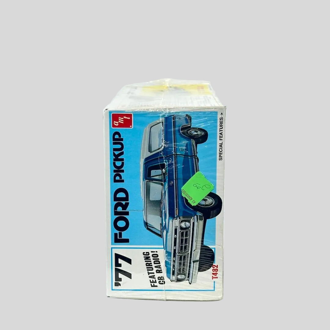 Model kit for '77 Ford Pickup still in plastic wrap against white background. 