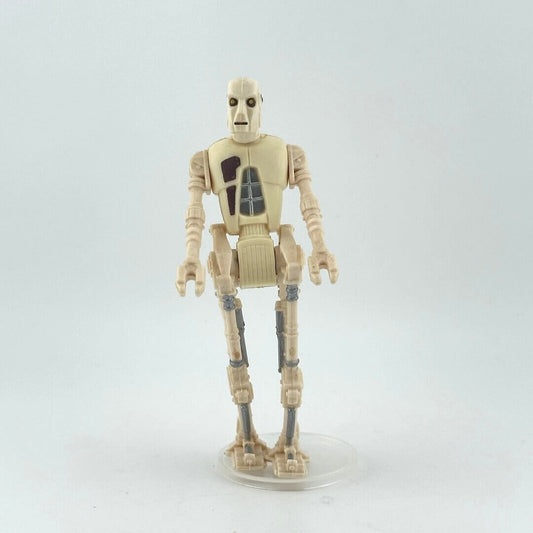 Toy figure of a beige robot on a white background