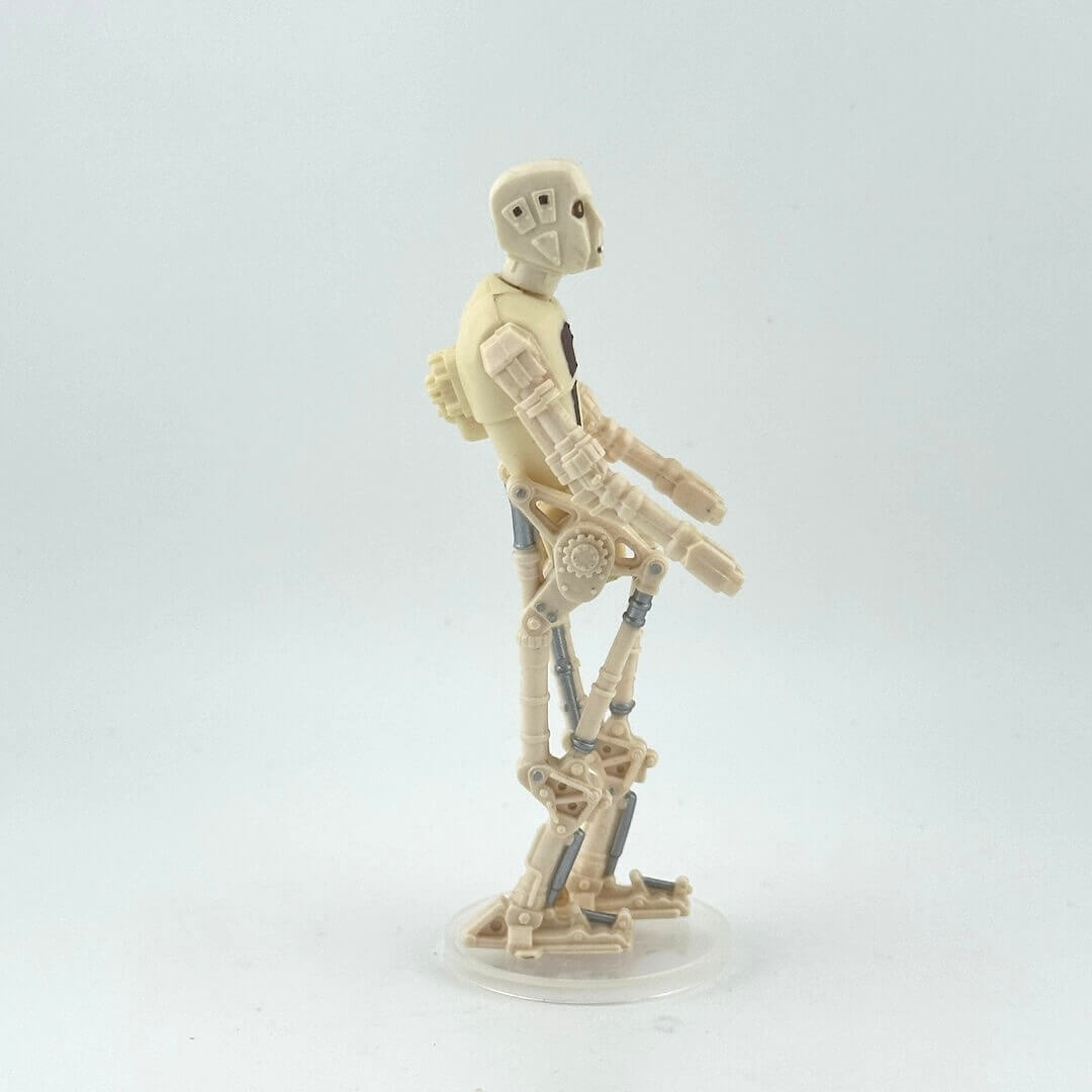 Toy figure of a robot on a white background, side view