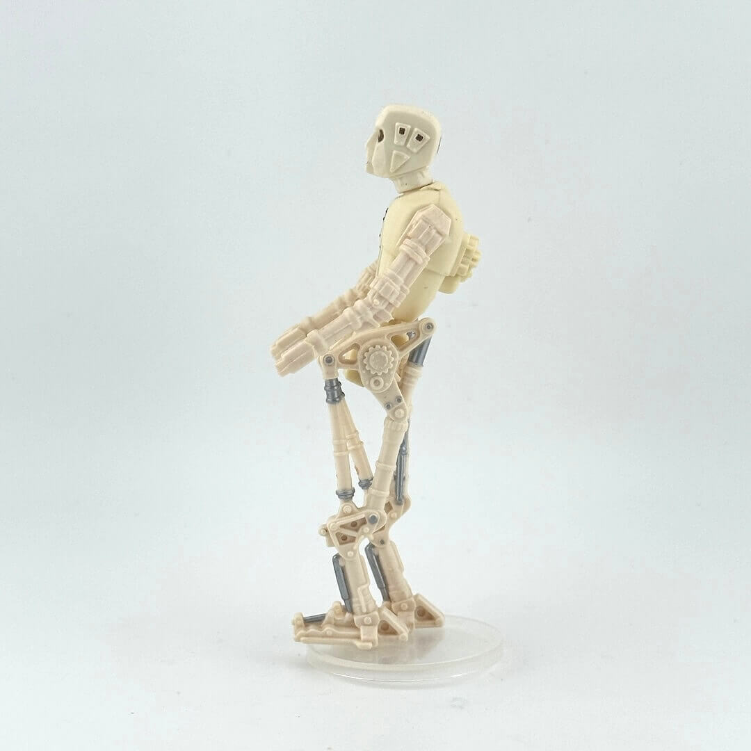 Toy figure of a robot on a white background, opposite side view