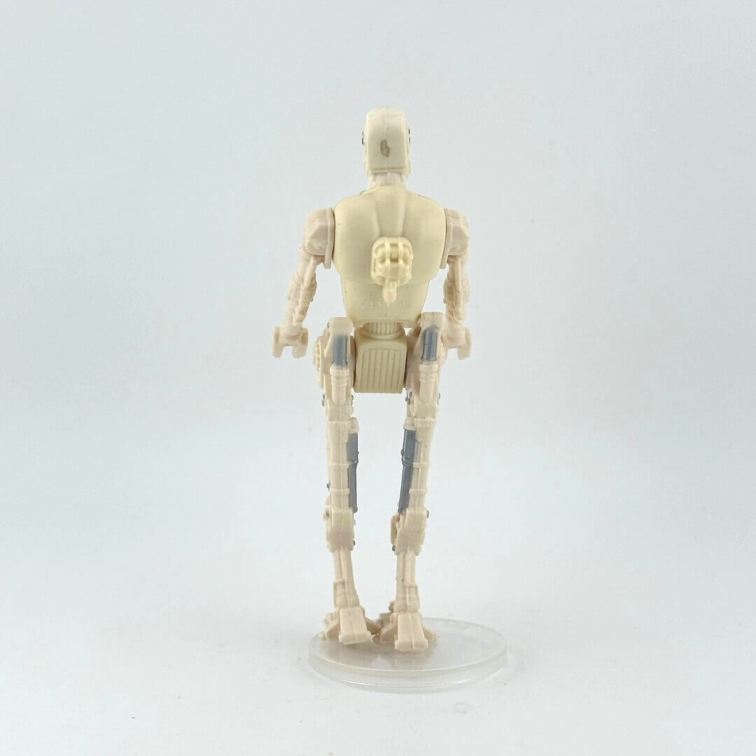 Toy figure of a robot on a white background, reverse view