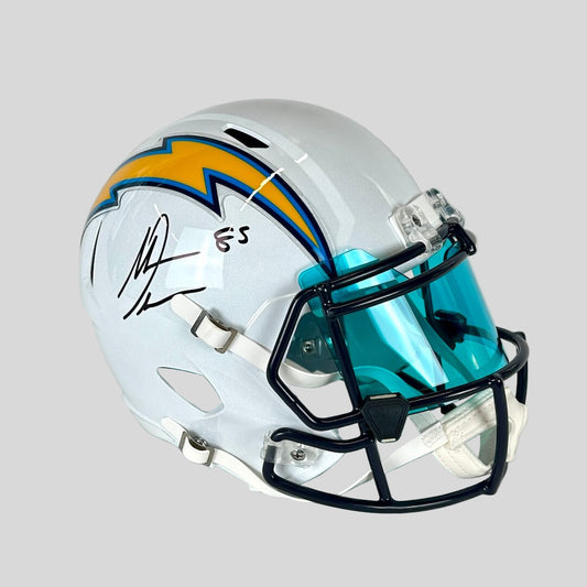 Football helmet with teal face guard and white shell on a light gray background