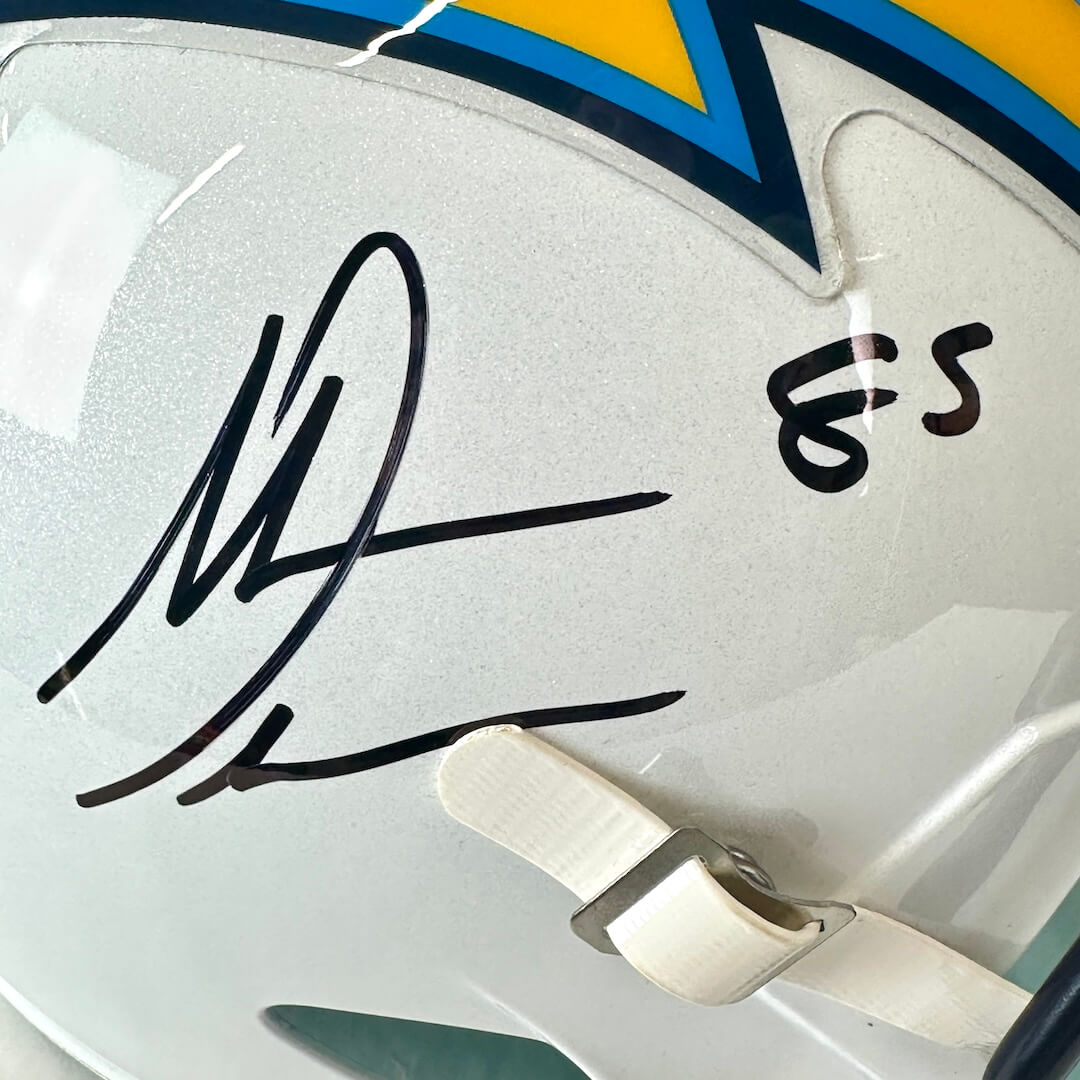 Close-up of a sports helmet with autographs and numbers on a white background