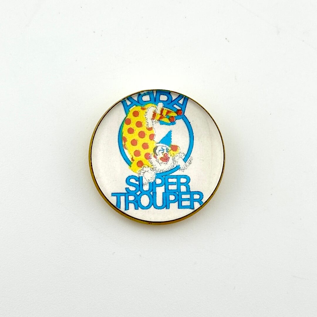 Circular pin with white background and clown illustration with "ABBA, Super Trouper" text. 