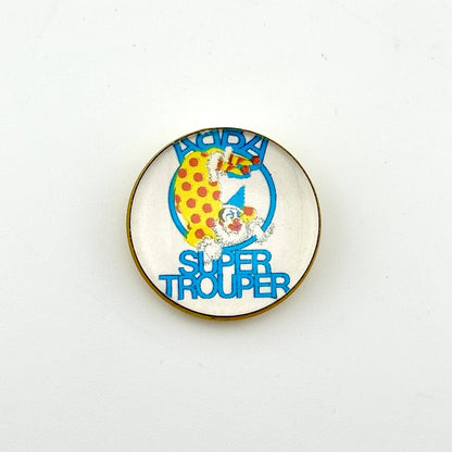 Circular pin with white background and clown illustration with "ABBA, Super Trouper" text. 