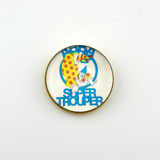 Circular pin with white background and clown illustration with "ABBA, Super Trouper" text. 