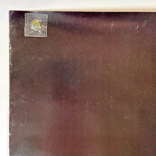 Top left corner with light wear to left edge.