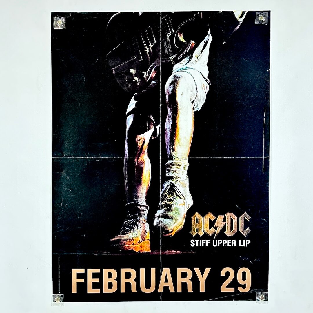 AC/DC 'Stiff Upper Lip' album cover with a boot and helmet on a dark background