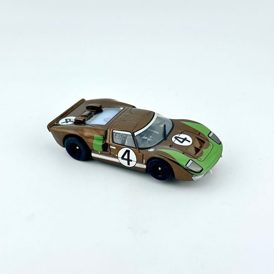 Model car with a brown and green design on a white background