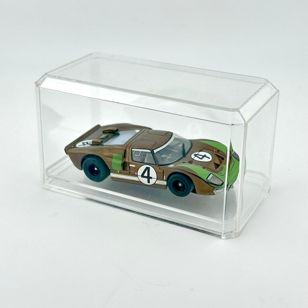 Model car in a clear display case on a white background