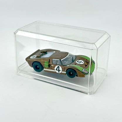 Model car in a clear display case on a white background