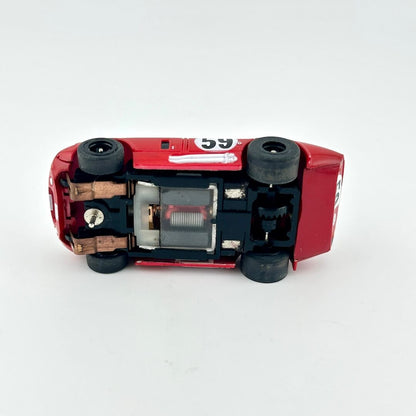 Red toy car with black wheels on a white background
