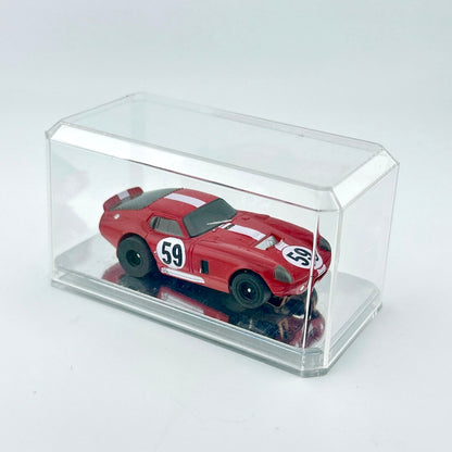 Red model car with white stripes in a clear display case on a light gray background