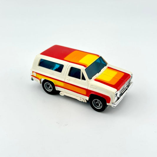 Model of a vintage Blazer with a colorful striped design on a white background