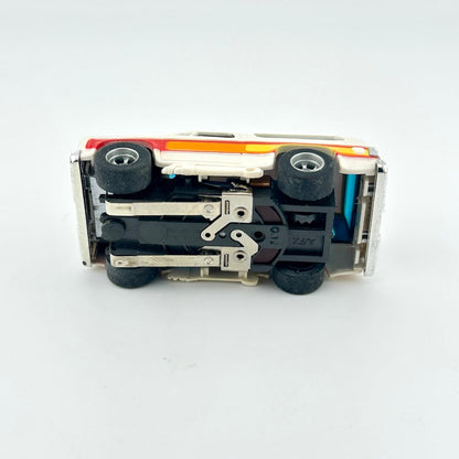 Underside of slot car against white background. 