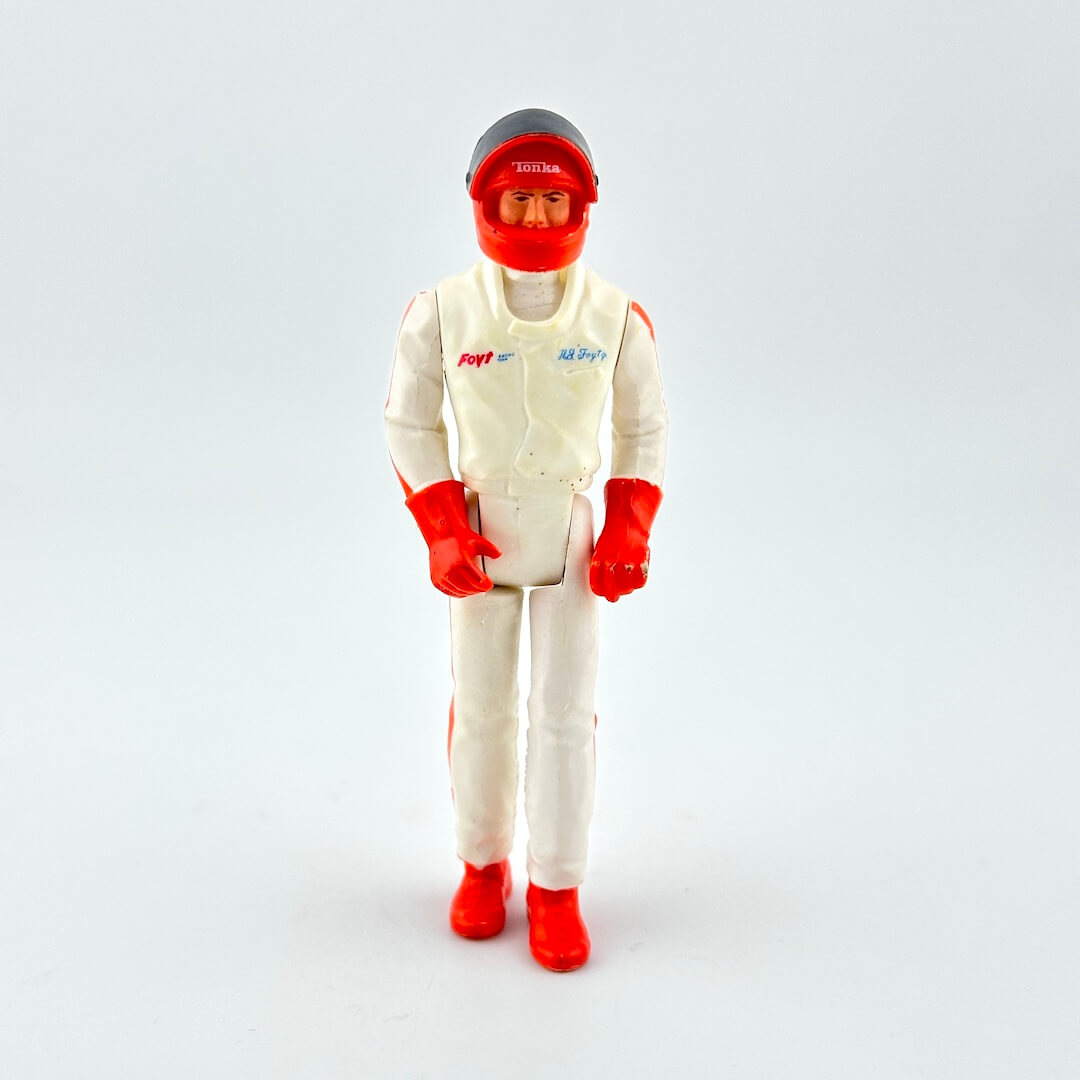 Action figure in a white suit with red accents on a light gray background