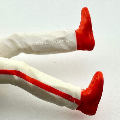 Vintage Tonka Toys figure legs with red shoes on a white background