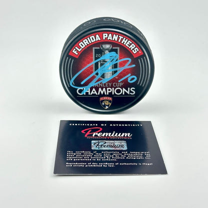 Puck with Florida Panthers Stanley Cup Champions branding and a certificate of authenticity on a white background