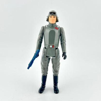 Toy figure in a gray space suit with a blue weapon on a white background