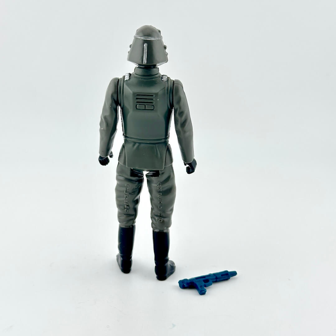 Action figure in a gray suit with a helmet on a white background