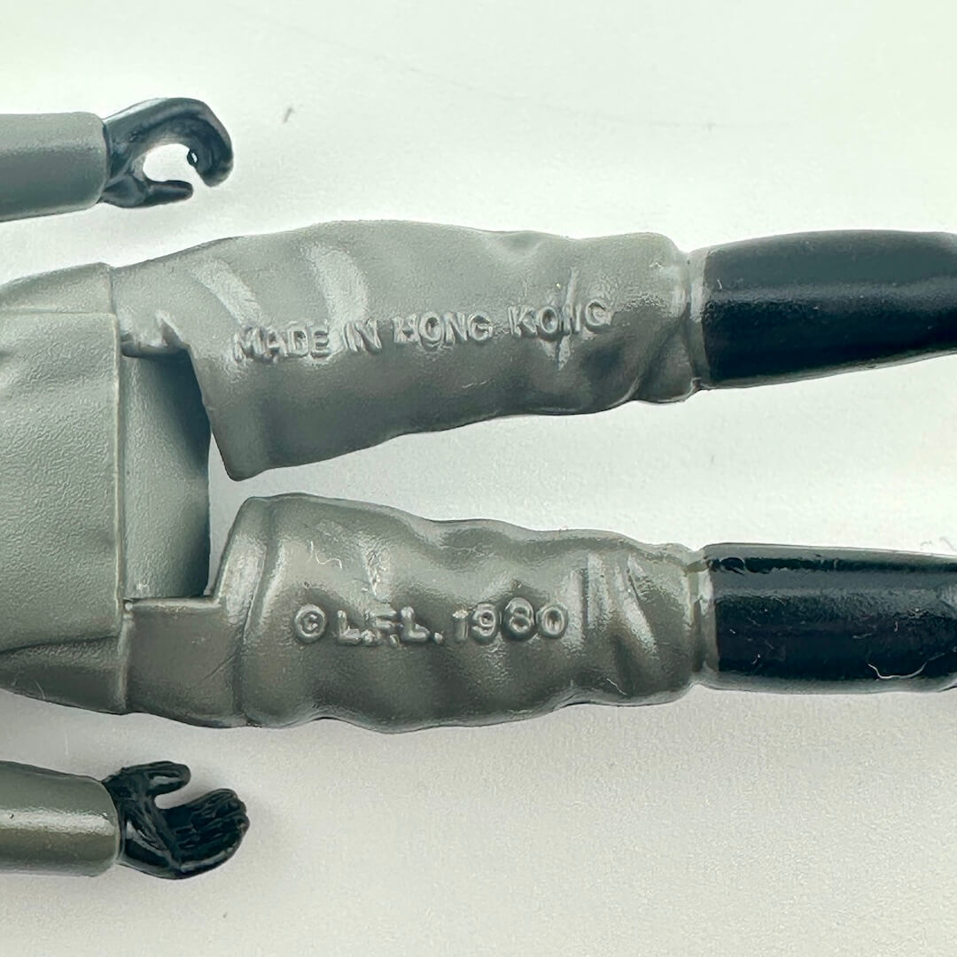Close-up of back of figure's legs to show COO and copyright information. 