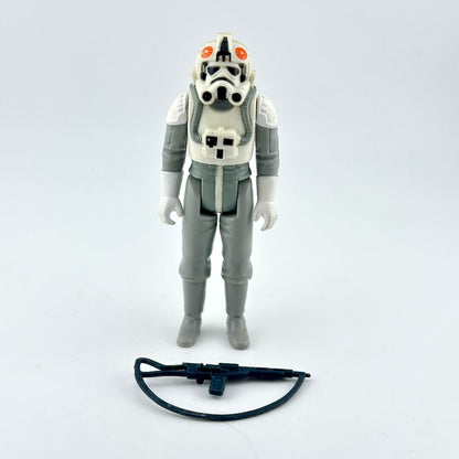 A vintage Star Wars plastic action figure of an AT-AT Driver in white and gray uniform with black accessory. 