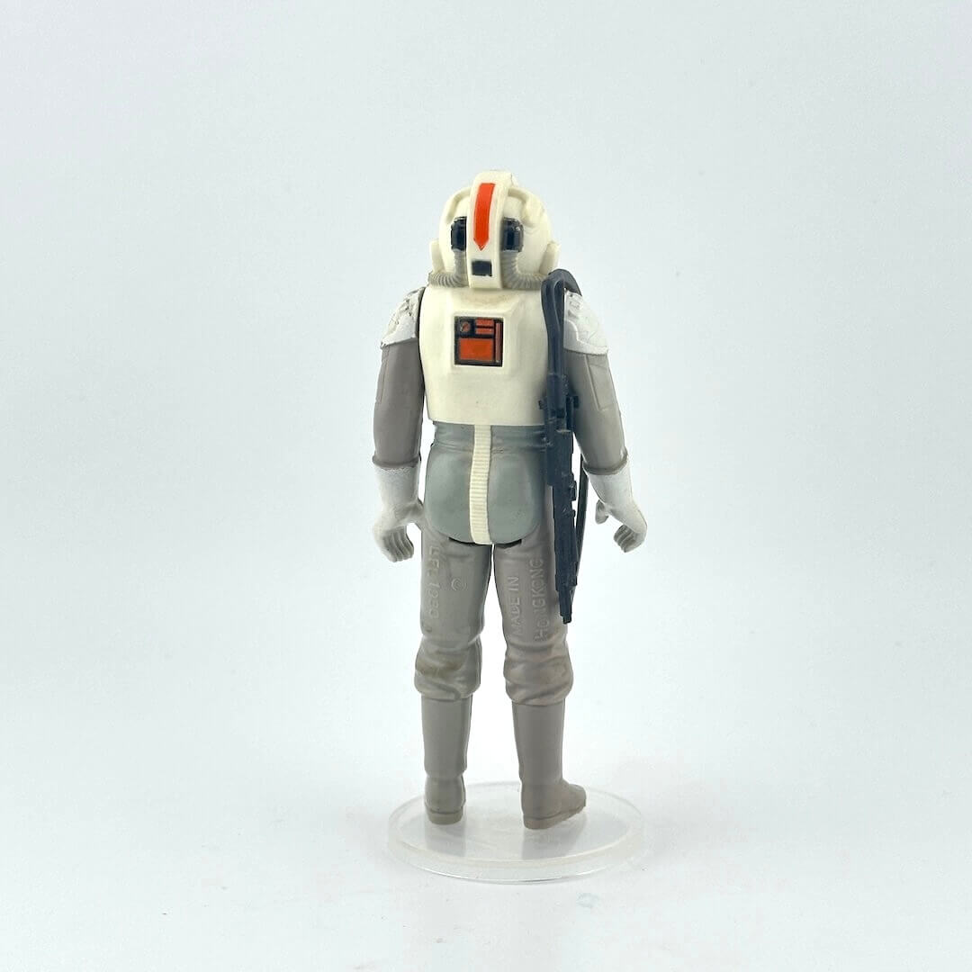Toy figure of a character in a gray and white suit with helmet on a white background