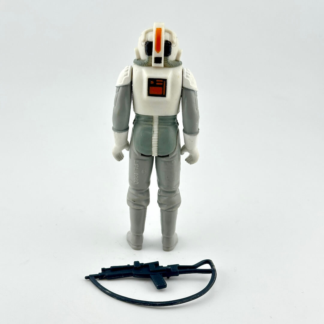 A vintage Star Wars action figure of a white and gray stormtrooper with black accessory.