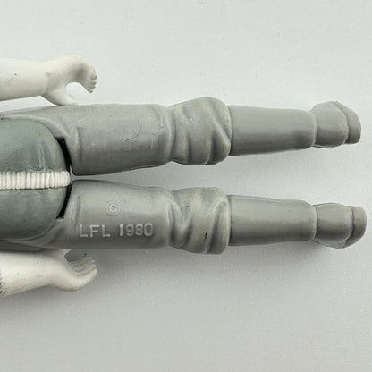 Close-up of a gray action figure's articulated legs and hands, showing the 'LFL 1980' molded into the pants.