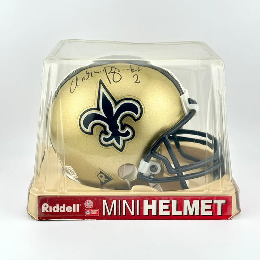 Gold mini football helmet with logo in clear packaging on a white background