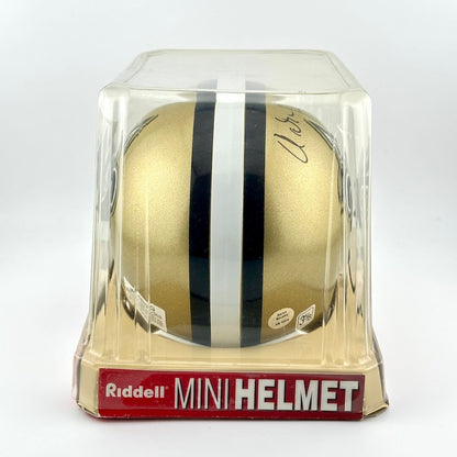 Gold mini football helmet with black and white stripes in clear packaging, featuring Riddell branding.