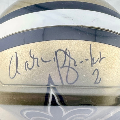 Close-up of a helmet with a signature and number on a reflective surface