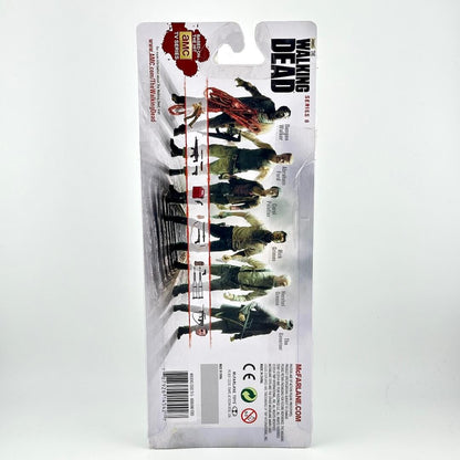Back view of a packaged action figure from The Walking Dead Series 8, showing other available figures. 