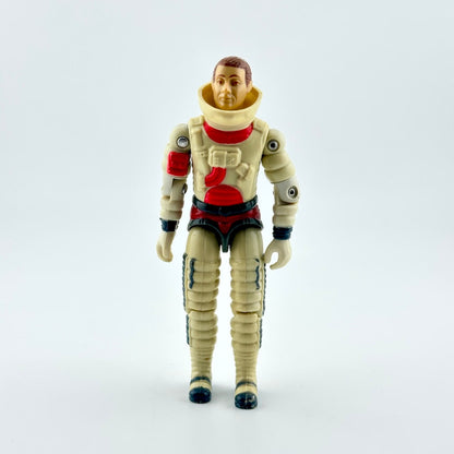 A vintage plastic astronaut action figure standing against a seamless light gray background. 