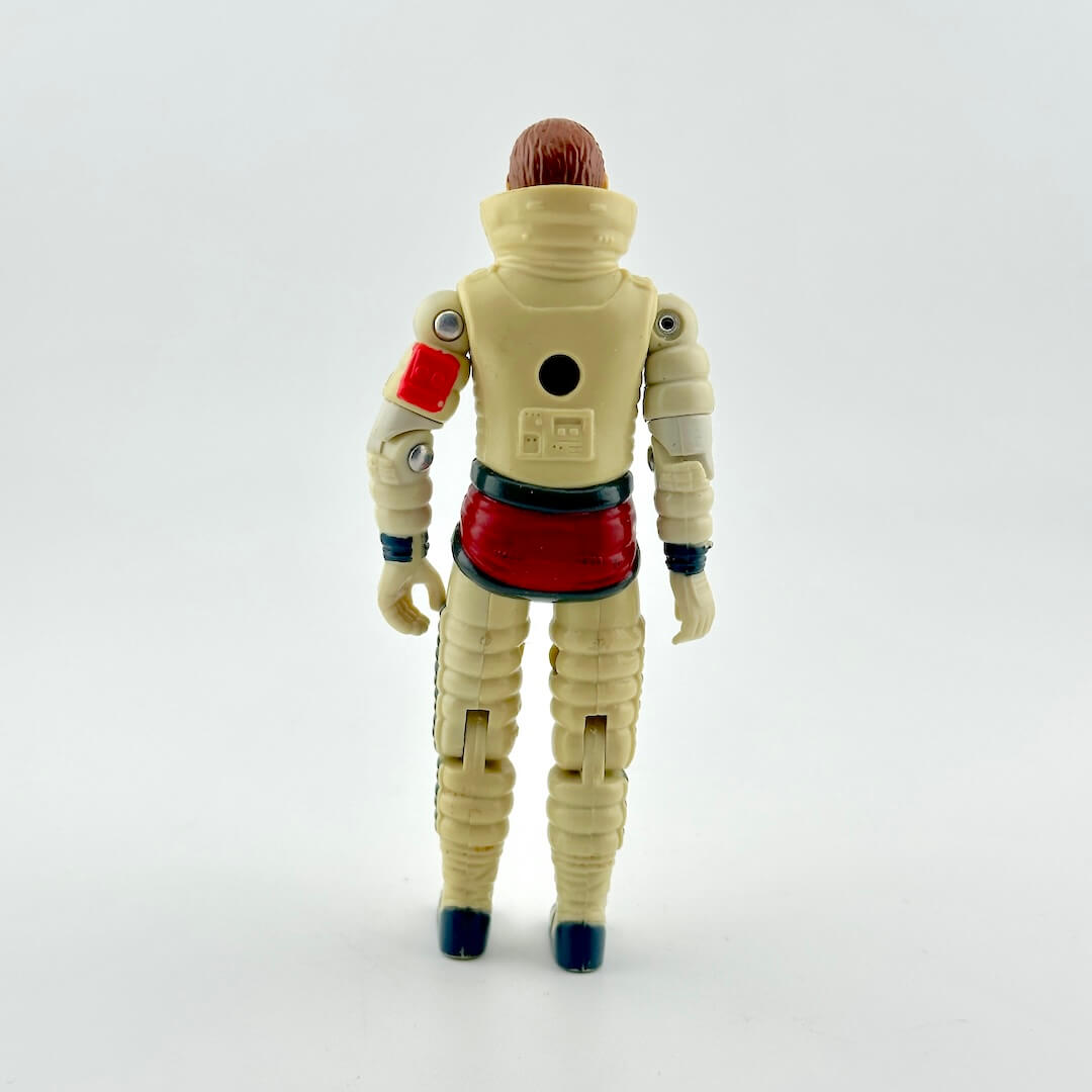 A vintage plastic action figure of a space astronaut shown from the back.