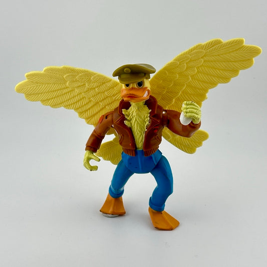 Yellow anthropomorphic bird in jeans, leather bomber jacket, & military cap. Holding white grenade. Front view.