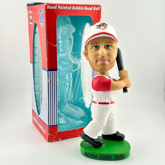 Bobblehead figure of a baseball player holding a bat in front of its packaging