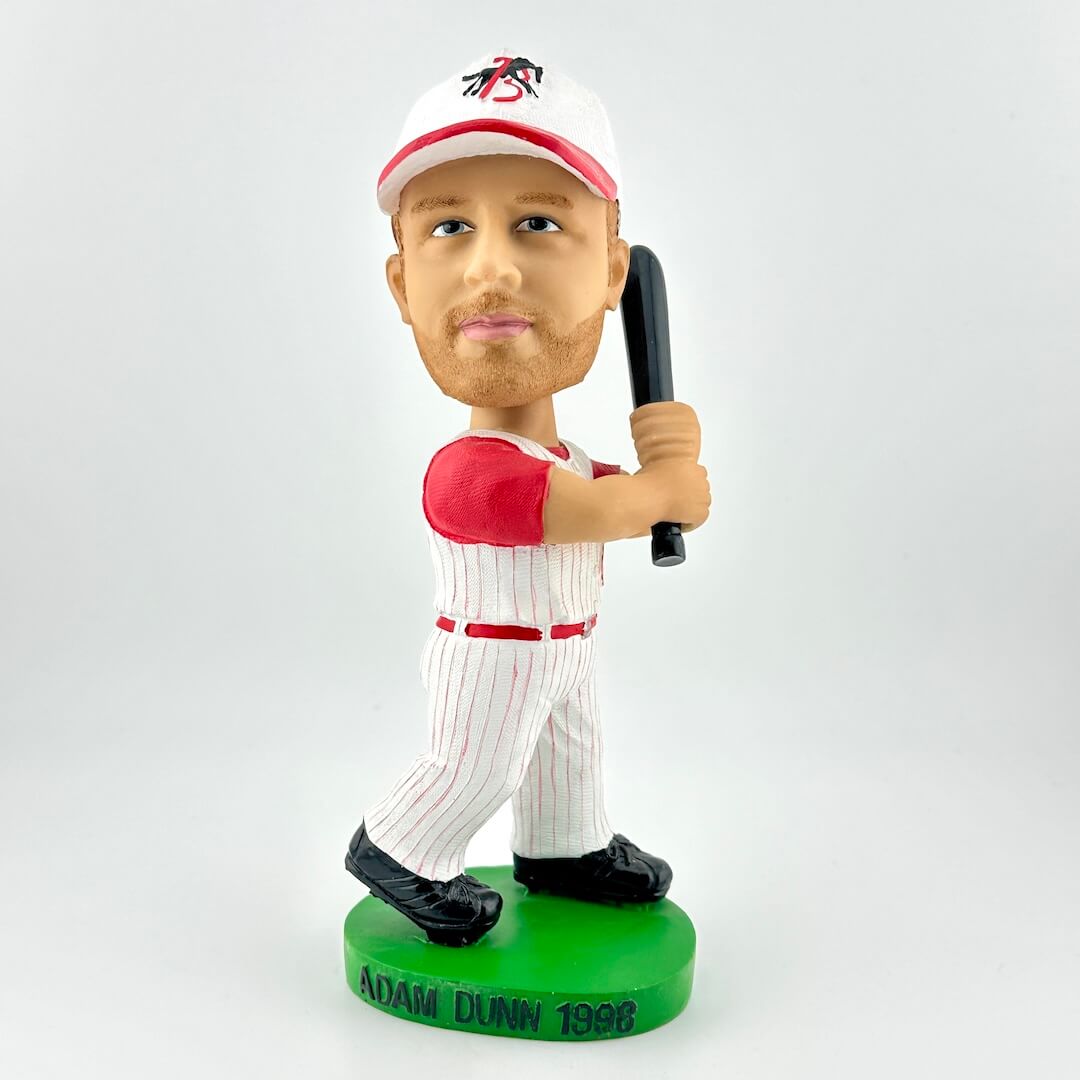 Bobblehead figure of a baseball player holding a bat on a white background