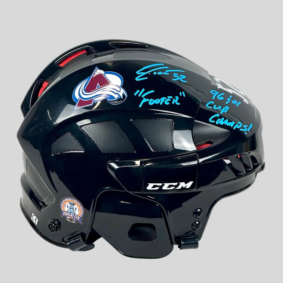 Black hockey helmet with Colorado Avalanche logo and autographs on a white background