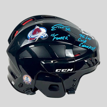 Black hockey helmet with Colorado Avalanche logo and autographs on a white background