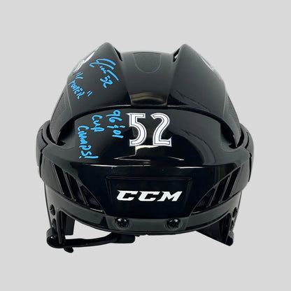 Black hockey helmet with autographs and numbers on a white background