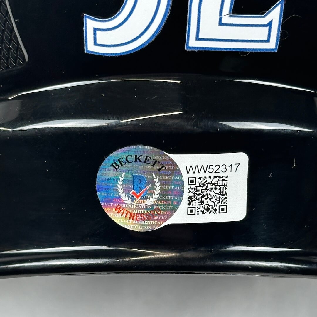 Beckett authentication label on a black surface with visible text and QR code.