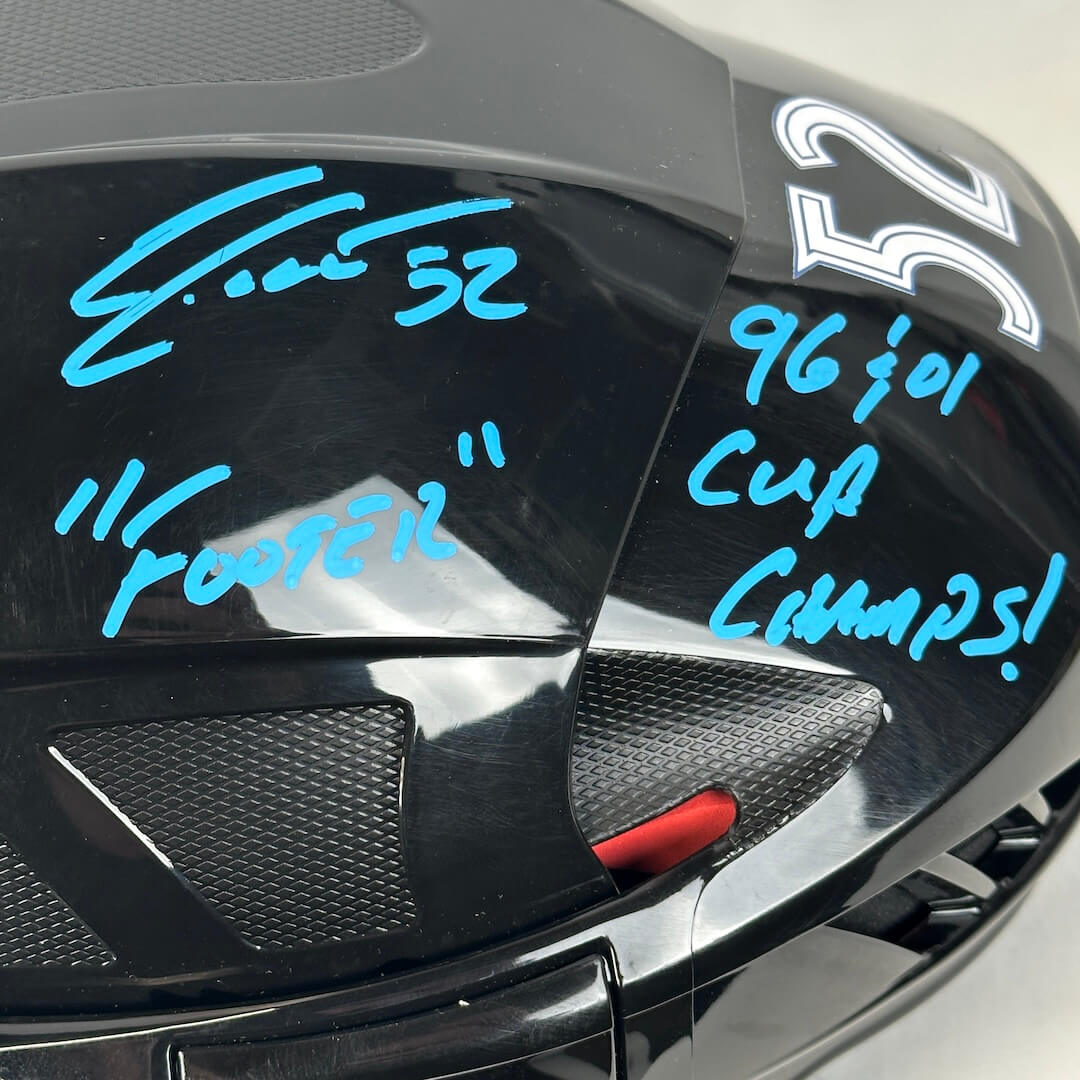 Close-up of helmet with hand-written text in blue marker.