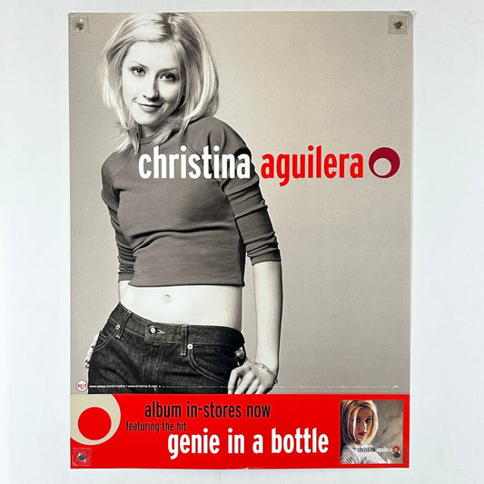 Promotional poster for Christina Aguilera's album 'Genie in a Bottle' featuring a woman in a casual outfit.
