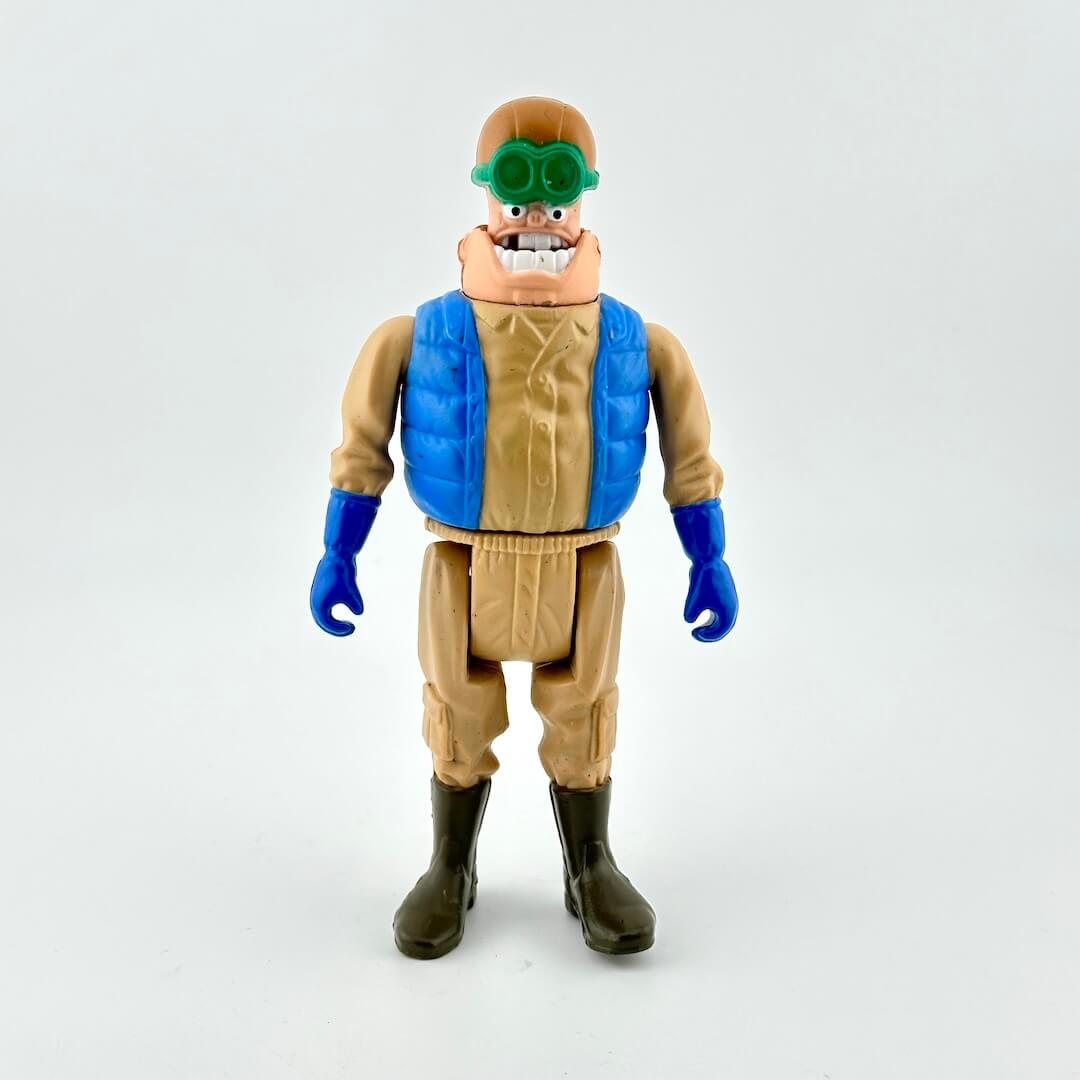 Action figure with a blue vest and tan pants on a white background