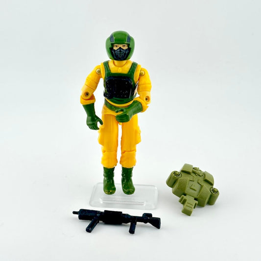 Toy figure in yellow and green outfit with accessories on a white background