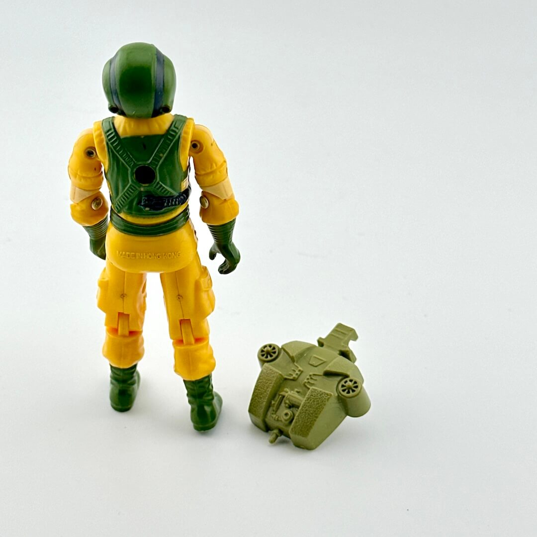 Action figure in yellow and green wetsuit with green pack against white background.