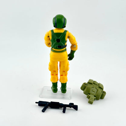 Toy figure in yellow and green outfit with accessories on a white background